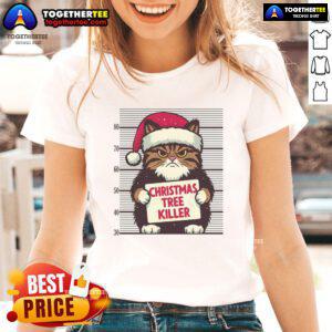 Funny cat mug shot wearing a red Santa hat, posing beside a Christmas tree. Perfect for a Merry Christmas cat tee!
