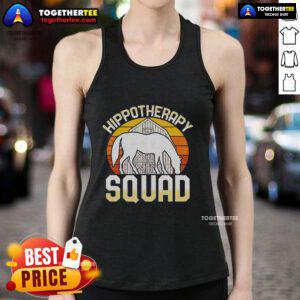 Equine-assisted horse therapy therapist at sunset wearing a tank top, showcasing the healing connection with horses.