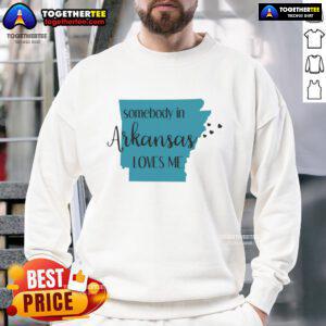 Person wearing a 'Somebody in Arkansas Loves Me' state sweatshirt, showcasing Arkansas pride and cozy fashion style.