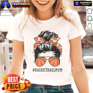 Pretty basketball mom with messy bun and sunshades wearing a ladies tee, showcasing pride in her basketball-loving family.