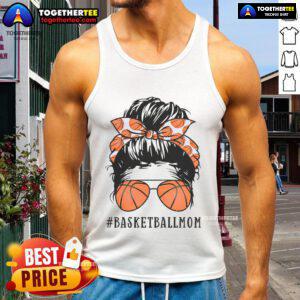 Pretty basketball mom in a messy bun wearing sunshades and a tank top, proudly supporting her child on the court.