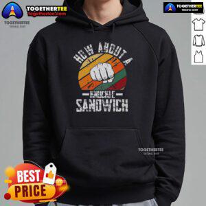 Boxing trainer wearing a 'How About A Knuckle Sandwich' hoodie, demonstrating techniques in a gym setting.
