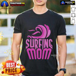 Surfing mom wearing a fun 'Top Surfing Mom' T-shirt, showcasing her love for surfing and motherhood on the beach.