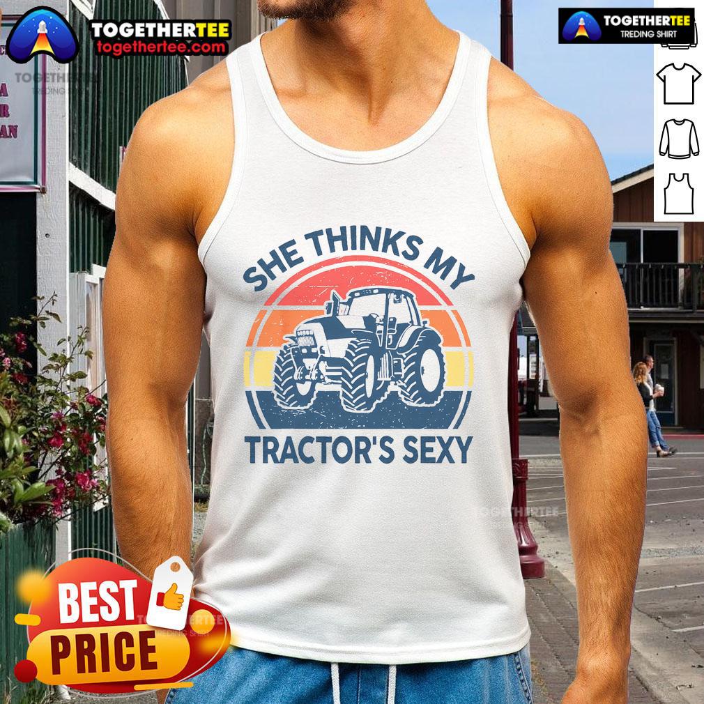 Vintage farmer tank top featuring a humorous quote: 'She thinks my tractor's sexy' with a fun design.