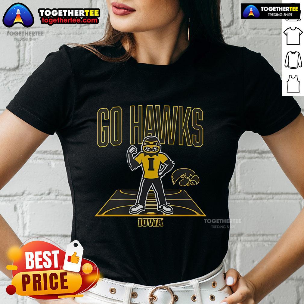 Iowa Hawkeyes basketball mascot on court with ladies wearing team tee, showcasing team spirit and pride.