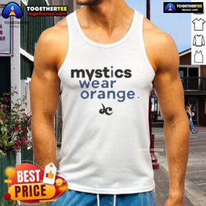 Nice mystics wearing orange tank tops, showcasing vibrant fashion and spiritual vibes in a sunny outdoor setting.