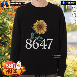 Alt Text: Floral sweatshirt featuring a vibrant sunflower design, perfect for spring fashion and casual outfits.