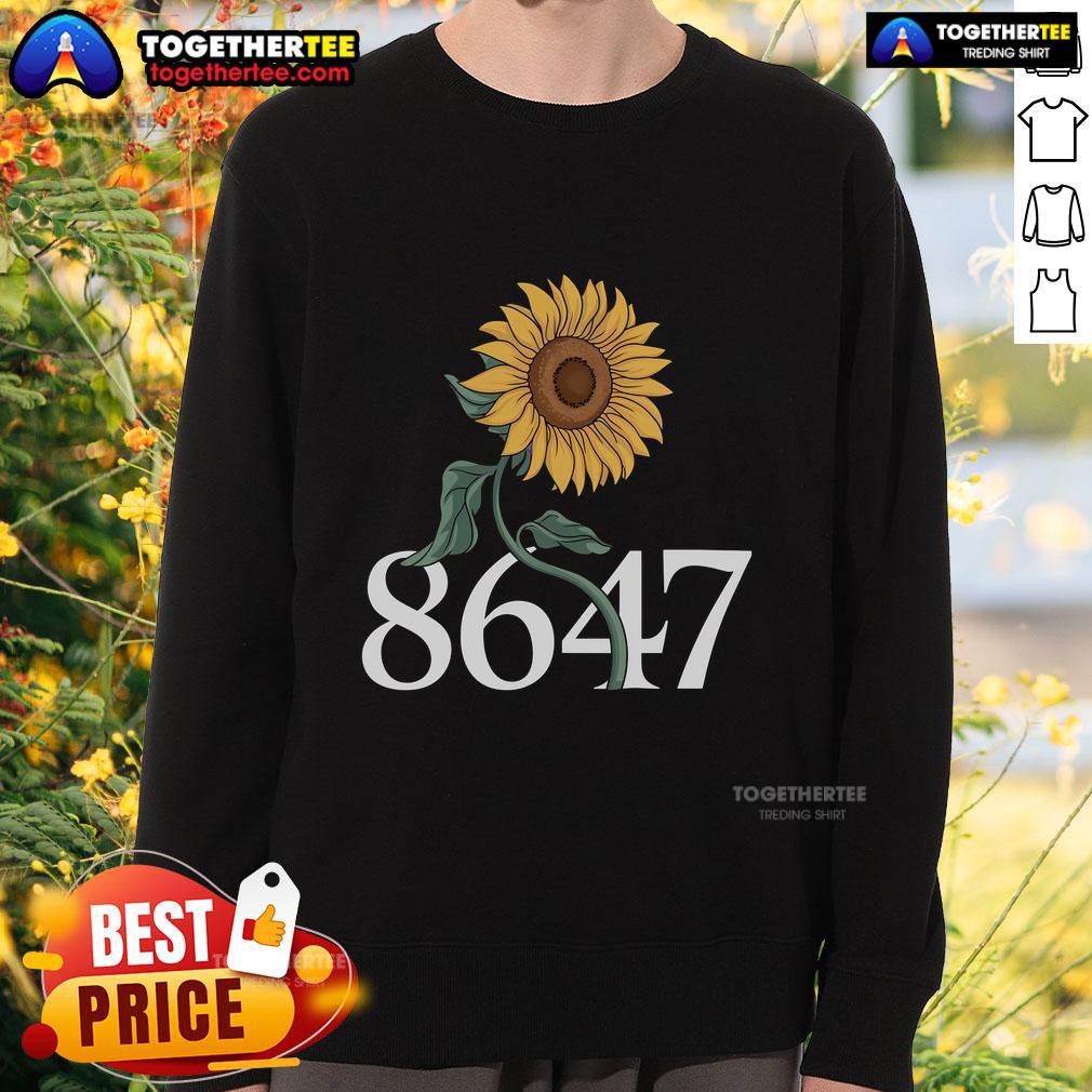 Alt Text: Floral sweatshirt featuring a vibrant sunflower design, perfect for spring fashion and casual outfits.
