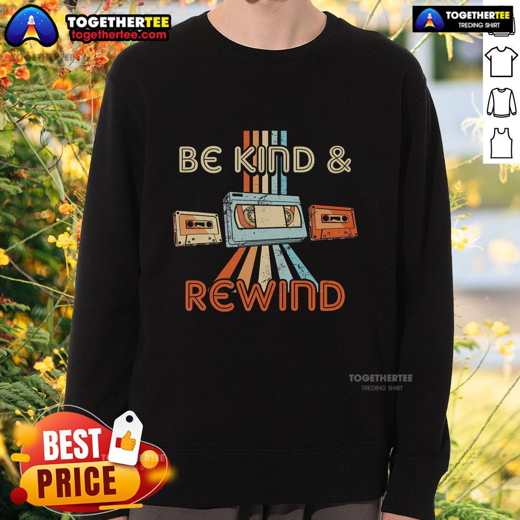 Vintage 90s sweatshirt featuring 'Be Kind, Rewind' slogan, capturing nostalgic 80s throwback style.