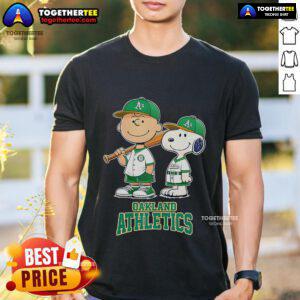 Alt Text: Top Oakland Athletics Charlie Brown and Snoopy baseball cartoon fan T-shirt featuring iconic characters in team colors.
