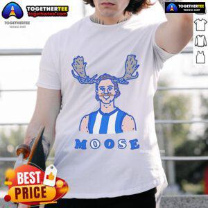 Official Moosebar Tcd T-Shirt displayed on a wooden background, showcasing its unique design and vibrant colors.