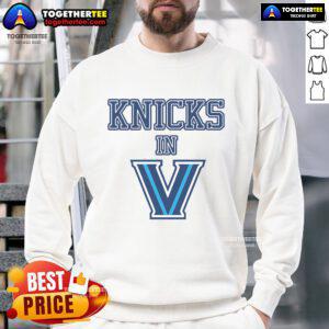 Person wearing a stylish New York Knicks sweatshirt, showcasing team pride in a vibrant urban setting.