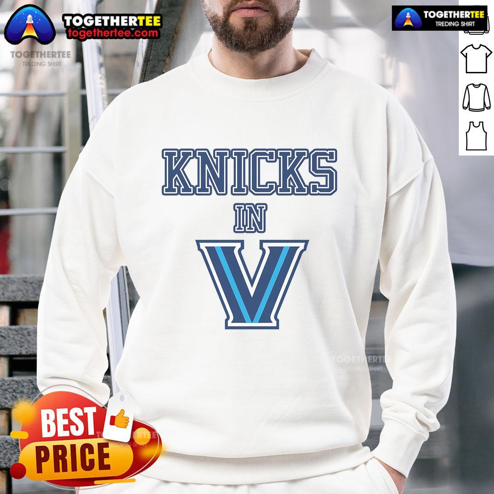 Person wearing a stylish New York Knicks sweatshirt, showcasing team pride in a vibrant urban setting.