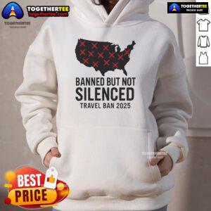 Alt Text: Protestor wearing 'Hot Banned But Not Silenced' hoodie during 2025 Trump travel ban protest, showcasing resistance.