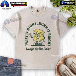 Good Twist It Right Burn It Bright Always On The Grind washed t-shirt displayed on a wooden background.