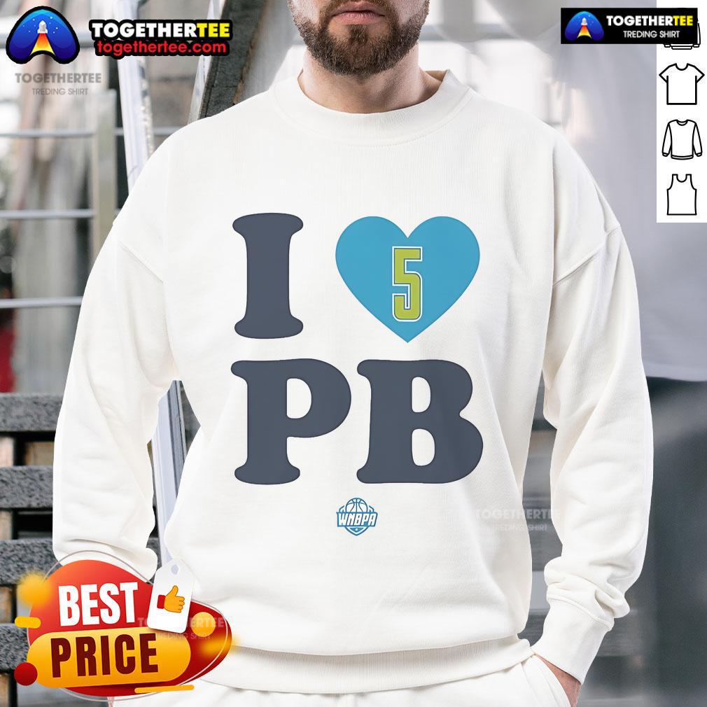 Paige Bueckers wearing a stylish I Love PB Dallas Wings sweatshirt, showcasing her love for basketball and team spirit.