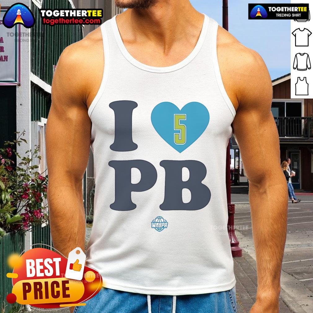 Happy Paige Bueckers wearing an 'I Love PB' Dallas Wings tank top, showcasing her love for basketball and team spirit.
