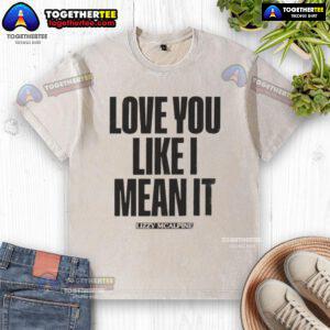 Official Love You Like I Mean It washed t-shirt in a casual setting, showcasing trendy style and comfortable fit.