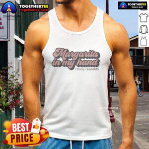 Charly Reynolds enjoying a premium margarita in hand, wearing a stylish tank top, perfect for summer vibes.