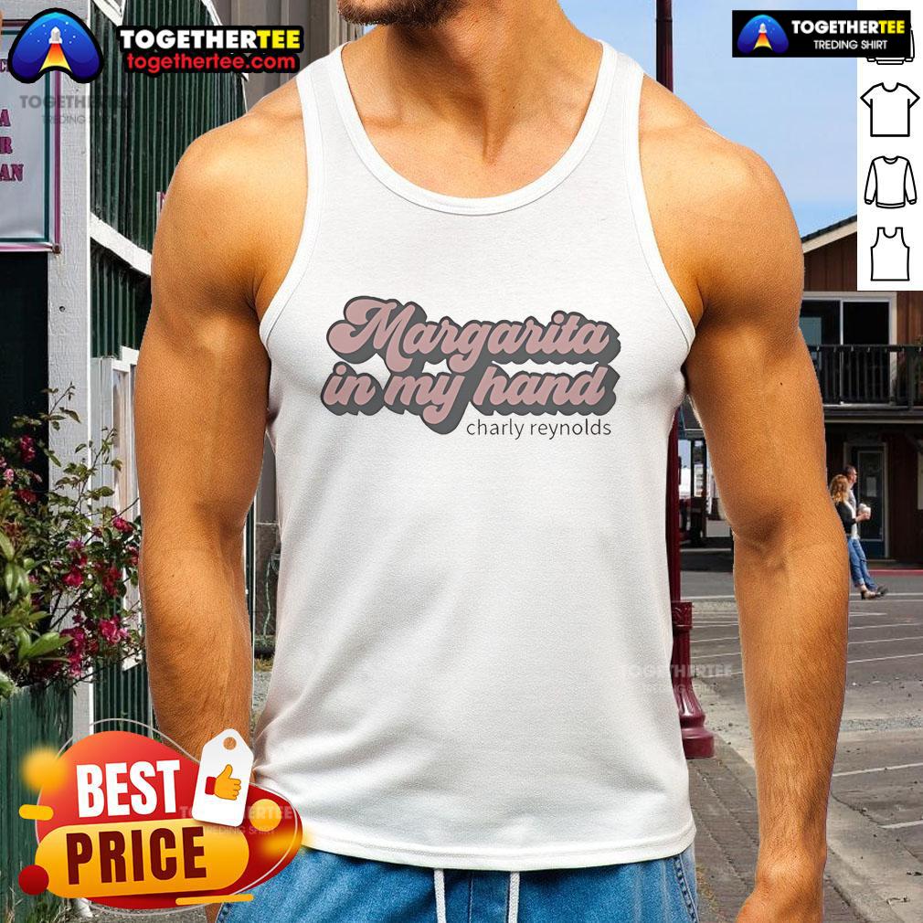 Charly Reynolds enjoying a premium margarita in hand, wearing a stylish tank top, perfect for summer vibes.