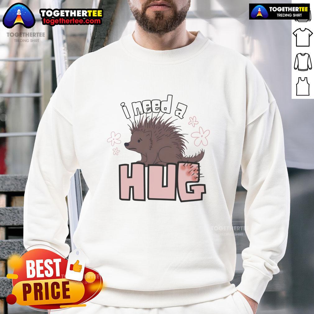Funny porcupine graphic on a cozy sweatshirt with 'I Need A Hug' text for animal lovers and humor enthusiasts.