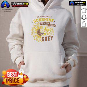 Cozy hoodie with 'Be Someone's Sunshine When Their Skies Are Grey' design, perfect for uplifting spirits on gloomy days.