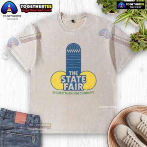 Official The State Fair Bigger Than You Thought washed t-shirt displayed on a hanger, showcasing vibrant colors and design.
