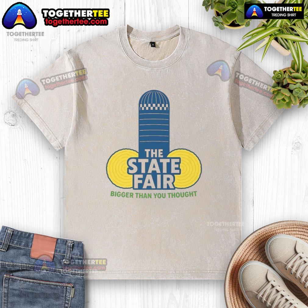Official The State Fair Bigger Than You Thought washed t-shirt displayed on a hanger, showcasing vibrant colors and design.