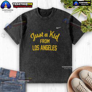 Alt Text: Official West Virginia Mountaineers 'Just A Kid From Los Angeles' washed t-shirt, featuring vintage design and team colors.