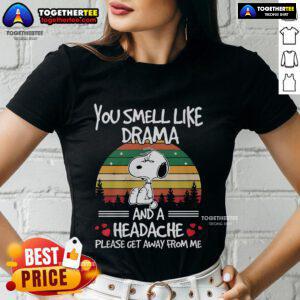Premium Snoopy tee featuring 'You Smell Like Drama And A Headache' design on a vintage sunset background for ladies.
