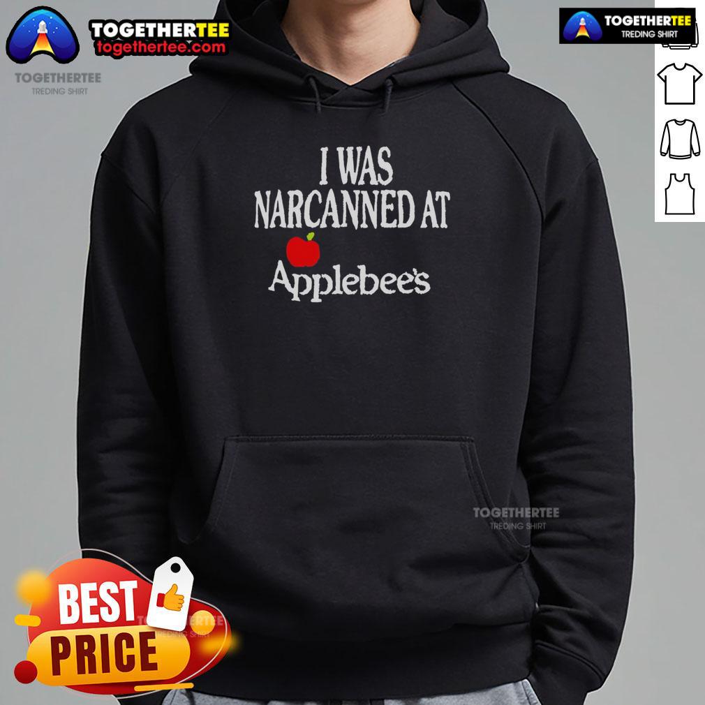 Person wearing a 'Pretty I Was Narcanned' Apple hoodie, showcasing a trendy design in a casual outdoor setting.