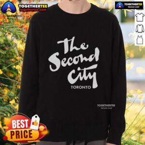 Cozy Pretty The Second City Toronto sweatshirt displayed on a wooden surface, showcasing its stylish design and vibrant colors.