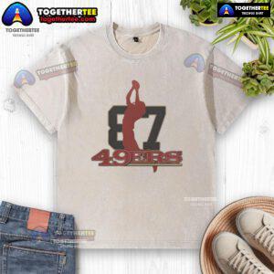 Top 49ers honoring the legacy of Dwight Clark with a vintage washed t-shirt showcasing his iconic catch.