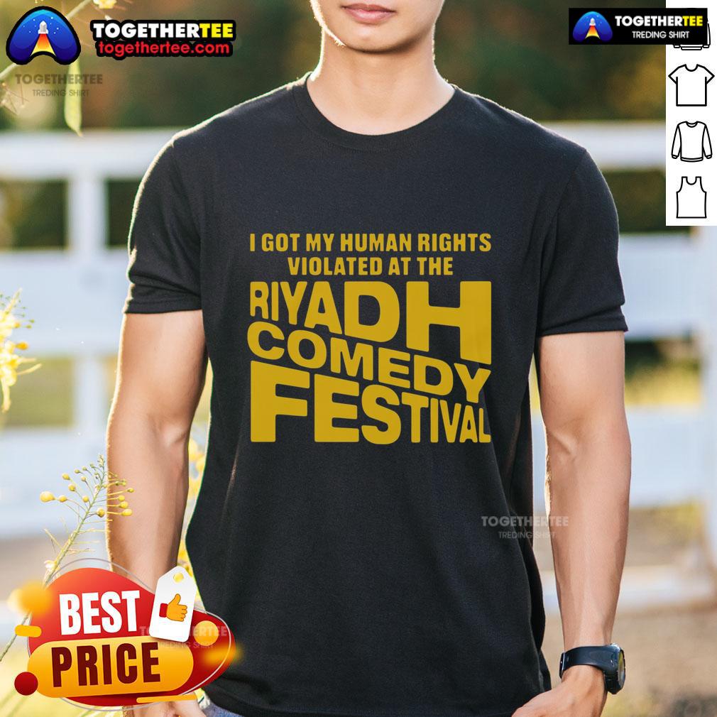 Alt Text: T-shirt featuring 'Good I Got My Human Rights Violated At The Riyadh Comedy Festival' slogan, highlighting human rights issues.