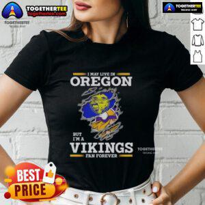 Good I May Live in Oregon But I'm A Minnesota Vikings Fan Forever Ladies Tee featuring team colors and logo.