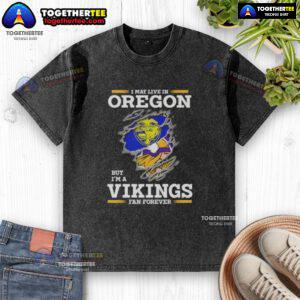 Alt Text: Good I May Live in Oregon but I'm a Minnesota Vikings Fan Forever washed t-shirt showcasing team pride.