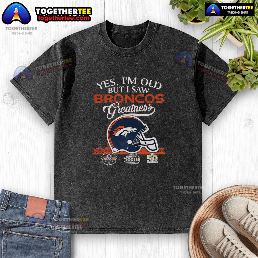 Vintage washed t-shirt featuring Denver Broncos Super Bowl helmet and skyline, perfect for fans celebrating team greatness.