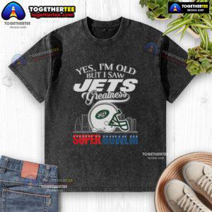 Alt Text: Vintage New York Jets Super Bowl III helmet graphic on a washed t-shirt with a city skyline design.