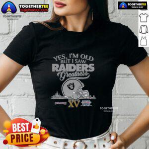Alt Text: Ladies tee featuring 'Top-Yes-Im-Old-But-I-Oakland-Raiders-Greatness' with Super Bowl helmet and skyline design.