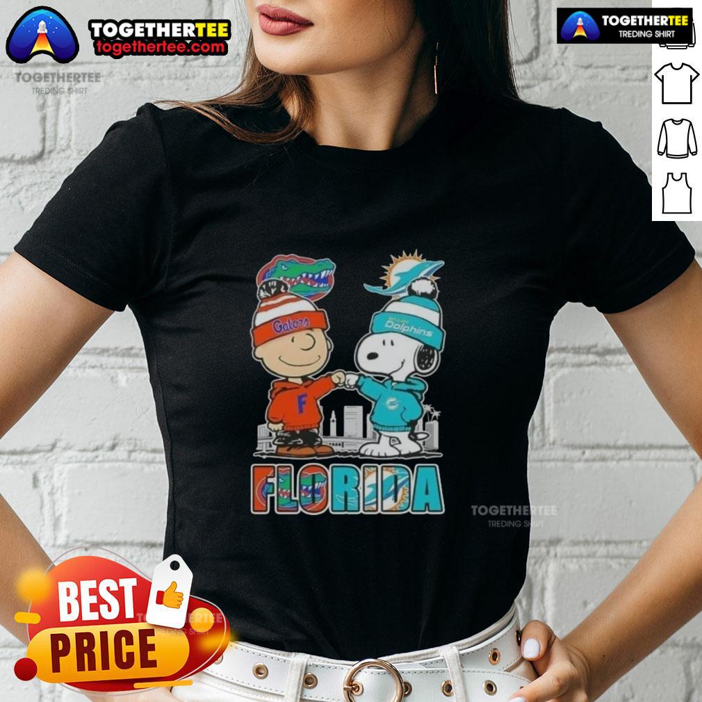Adorable Charlie Brown and Snoopy graphic on a Florida Gators and Miami Dolphins skyline ladies tee.