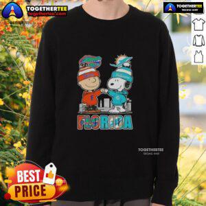 Alt Text: Cute Charlie Brown and Snoopy sweatshirt featuring Florida Gators and Miami Dolphins skyline design.