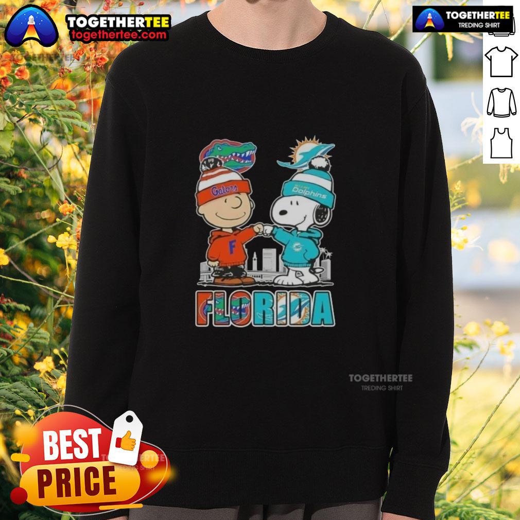 Alt Text: Cute Charlie Brown and Snoopy sweatshirt featuring Florida Gators and Miami Dolphins skyline design.
