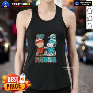 Cute Charlie Brown and Snoopy wearing Florida Gators and Miami Dolphins tank top against a vibrant skyline.