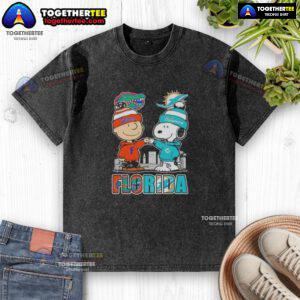 Alt Text: Cute Charlie Brown and Snoopy graphic on a Florida Gators and Miami Dolphins skyline washed t-shirt.