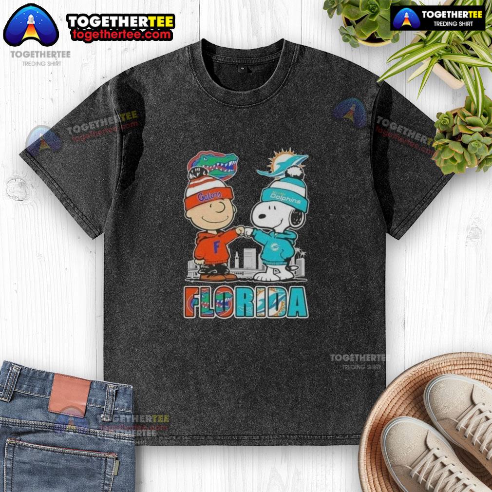 Alt Text: Cute Charlie Brown and Snoopy graphic on a Florida Gators and Miami Dolphins skyline washed t-shirt.