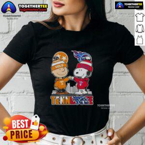 Alt Text: Cute Charlie Brown and Snoopy graphic on Tennessee Vols x Titans skyline ladies tee shirt design.