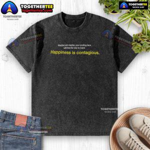 Smiling person wearing a 'Happiness is Contagious' washed t-shirt, spreading joy and positivity.