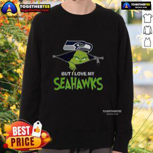 Alt Text: Cozy Grinch sweatshirt featuring 'I Hate People But I Love My Seattle Seahawks' for festive football fans.