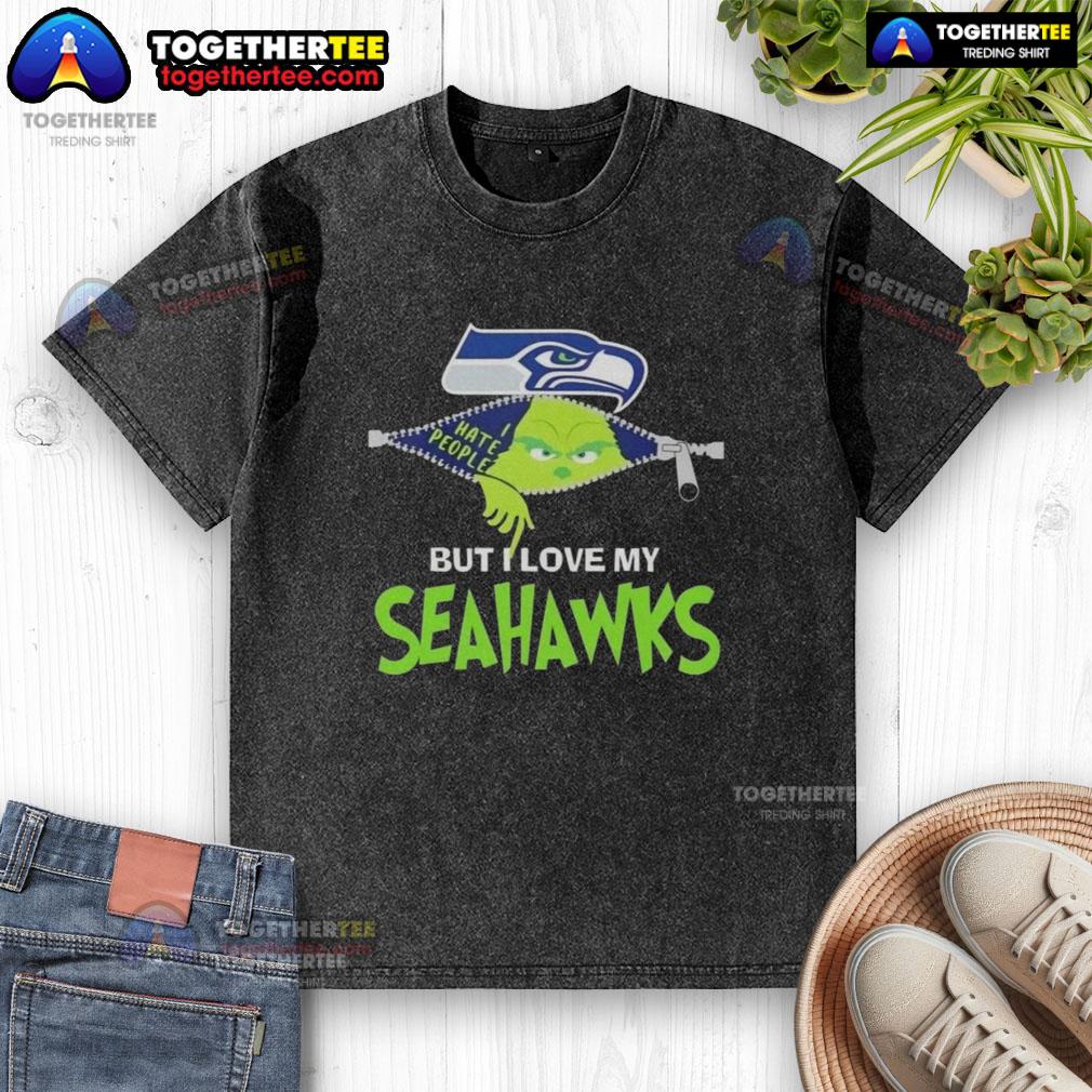 Alt Text: Original Grinch Christmas design on a washed t-shirt featuring Seahawks colors, perfect for Seattle Seahawks fans.