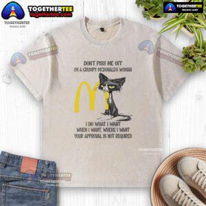Grumpy woman in a McDonald's-themed shirt, embodying a 'good tired' cat vibe, humorously asserting her independence.